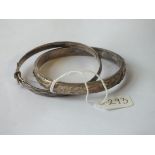 Two silver hinged bangles – one with gold overlay