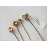Four various gold stick pins some set with stones