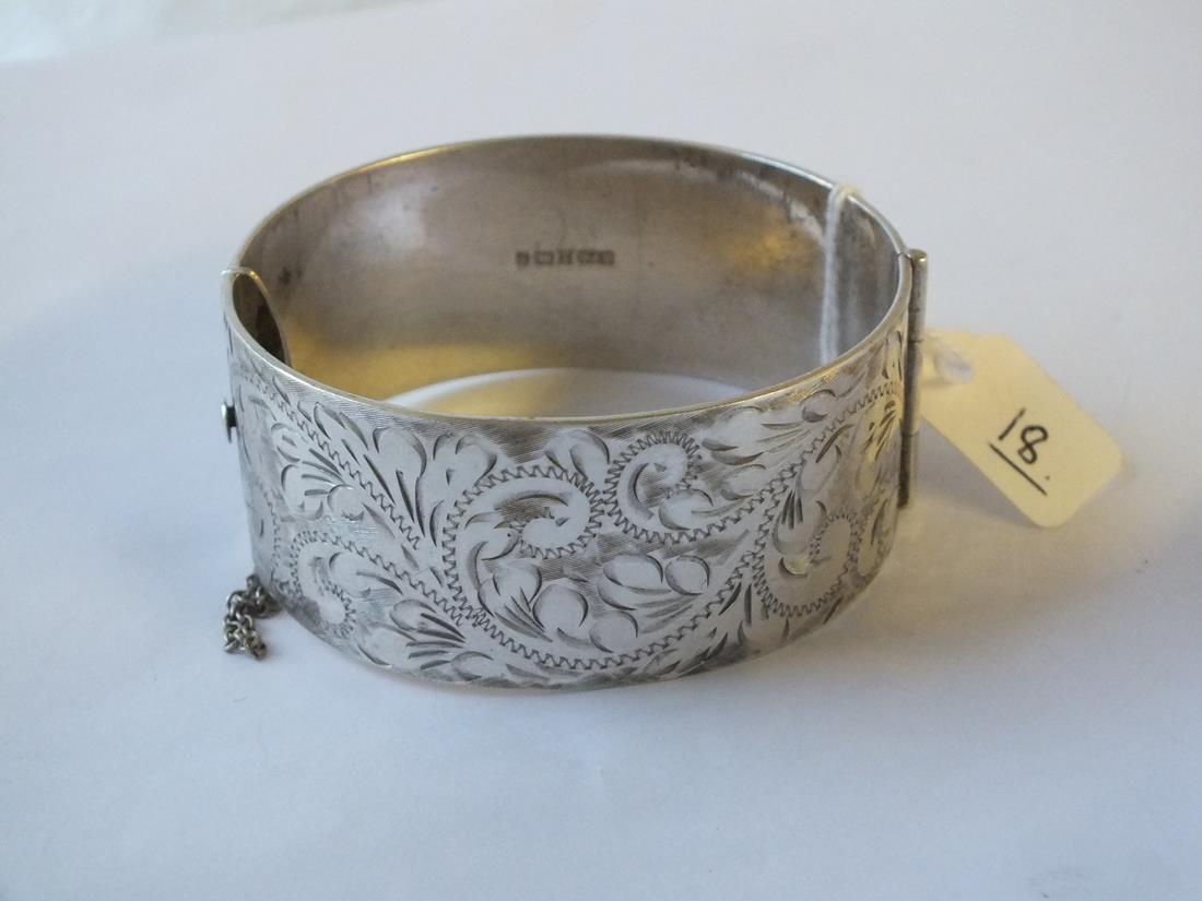 Wide silver hinged bangle engraved with scrolls – 73gm