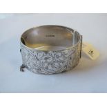 Wide silver hinged bangle engraved with scrolls – 73gm