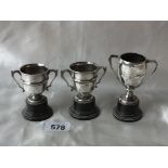 Group of small trophy cups, largest 2.5” over handles Shef