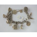 Silver charm bracelet set with numerous charms 37g