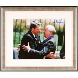 Gorbachev, Mikhail signed photograph meeting Ronald Regan. A colour 7" x 9" photograph of the Soviet