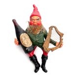 1960s Guinness leprechaun. A figure of a leprechaun dressed in a red pointed hat, green coat and red