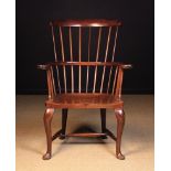 A 19th Century Mahogany Comb-back Windsor Armchair of generous proportions.
