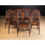 A Set of Wheel-back Windsor Kitchen Dining Chairs comprising of one armchair and six side chairs,