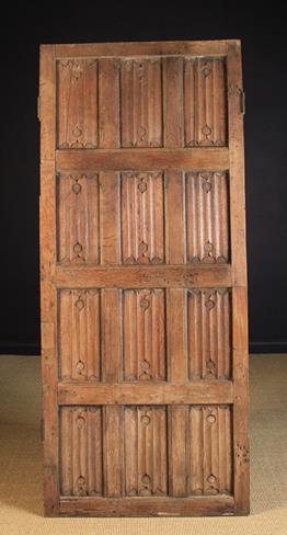 A 16th Century Gothic Panelled Oak Door composed of three rows of four linen fold carved panels in