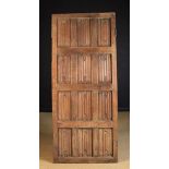 A 16th Century Gothic Panelled Oak Door composed of three rows of four linen fold carved panels in