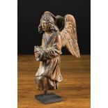 A Delightful Late 16th Century Carved Wooden Angel depicted in profile knelt praying,