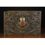 A 19th Century Oak Armorial Panel carved in the renaissance style with entwined scrolls of leaves