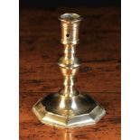 A Late 17th Century Candlestick with knopped stem peened to an octagonal base with circular dished