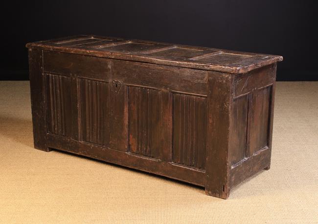 A Large Late 16th/Early 17th Century Oak Coffer having a four panelled lid and front: The front
