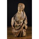 A 15th Century Polychrome Wood Carving of a Saint wearing a draped robe and belted tunic;