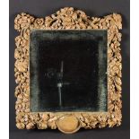 An Elaborately Carved 18th Century Limewood Mirror in the Manner of Grindling Gibbons.