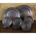 A Collection of Pewter Plates: A large charger with moulded rim 18 in (46 cm) in diameter stamped