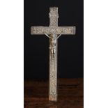 An 18th Century French Wooden Crucifix with decorative pierced pewter mount depicting Christ
