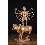 A 19th Century Gilt Metal Figure of The ten-armed Goddess Durga stood upon water buffalo's back,