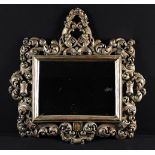 An Italian Baroque Silvered Gilt-wood Mirror.