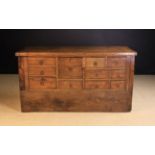 An 19th Century Elm Counter. The thick well-patinated plank top with cleated ends.