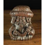 A 16th Century Oak Figural Corbel carved as the head & shoulders of a bearded man depicted with