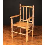 An Early 19th Century Turned Beechwood Doll's Chair.
