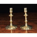 A Pair of Small English 18th Century Brass Candlesticks with knopped stems and petalled bases,