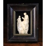 A 17th Century Ivory Carving of Virgin & Child sat upon billowing clouds with a winged angel's head