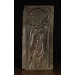 A 16th Century Carved Arcaded Oak Panel depicting the decapitated figure of Saint Dennis holding