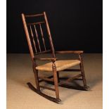 A 19th Century Ash & Elm Rush-Seat Spindle-Back Rocking Chair.