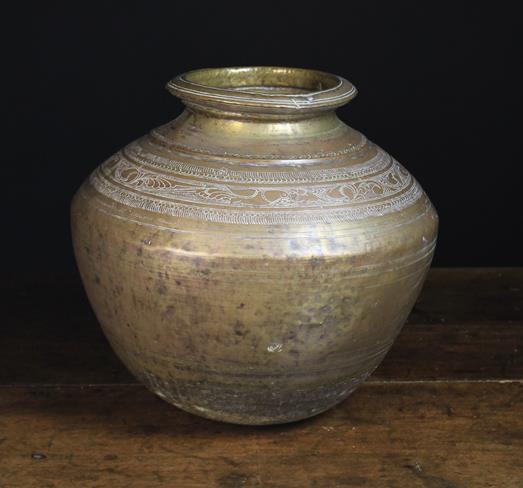 A 19th Century South Indian Round-bottomed Bulbous Brass Pot decorated with engraved shoulder bands,