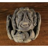 A 16th Century Architectural Stone Boss carved in the form of a man poking out his tongue and