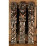 A Set of Three 17th Century Oak Terms carved as a Mermaid caryatid and Mermen bearing scrolled