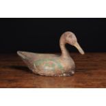 A 19th Century Painted Wooden Decoy Duck, 12 in (31 cm) in length.