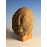 A Carved Stone Head mounted on an oak stand, 10½ in (26 cm) overall height.