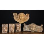 A Group of Ornamental Carved Wooden Face Masks: A set of three small 17th century appliqués