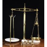 A Pair of 19th Century French Brass Weighing Scales and a set of seven Imperial brass bell weights