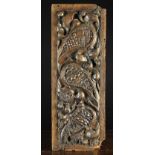 A 16th Century Carved Oak Panel enriched with crested foliage scrolling around three 'boteh' motifs