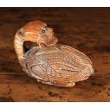 An Early 19th Century French Coquilla Nut Snuff Box elaborately carved with the folklore figure of