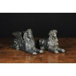 A Pair of Bronze Patinated Spelter Reclining Sphinxes; one winged with the head of a Pharaoh,