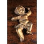 A 19th Century Relief Cast Iron Cherub painted gold, 13 ins (33 cm) in height.