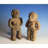 A Pair of Ethnic Stone Carved Figures of male 9¾ in (30 cm) high & female 12¼ in (31 cm) high.