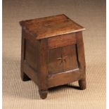 An 18th Century Joined Oak Box Stool with hinged lid above splayed panel sides inlaid with a