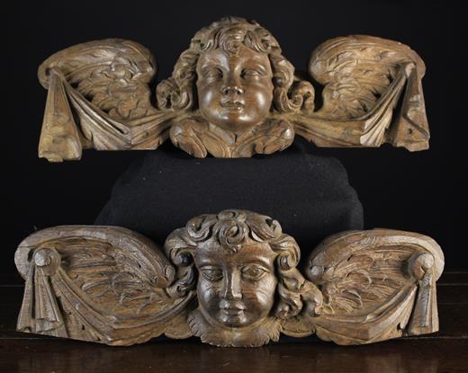 A Similar Pair of 18th Century Relief carved Appliqués/Wall Mounts in the form of curly haired