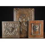 Three Antique Carved Oak Panels: A fielded panel with ogee moulded upper corners and a facemask