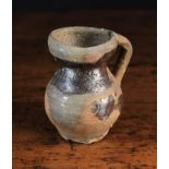 A Small Medieval Earthenware Jug with patches of lead glaze, 4 in (10 cm) in height.