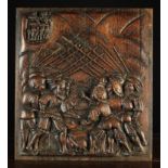 A 16th Century Oak Panel carved in relief with a Battle Scene;