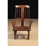An 18th Century Rustic Pine, Ash and Elm Comb-back Armchair.