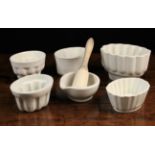 Five White Glazed Pottery Jelly Moulds & a white ceramic pestle & mortar;