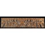 A 17th Century Flemish Carved oak Drawer Front decorated with winged cherubs blowing hunting horns,