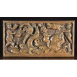 A Flemish Renaissance Carved Oak Panel depicting a cherub riding on the back of a windswept